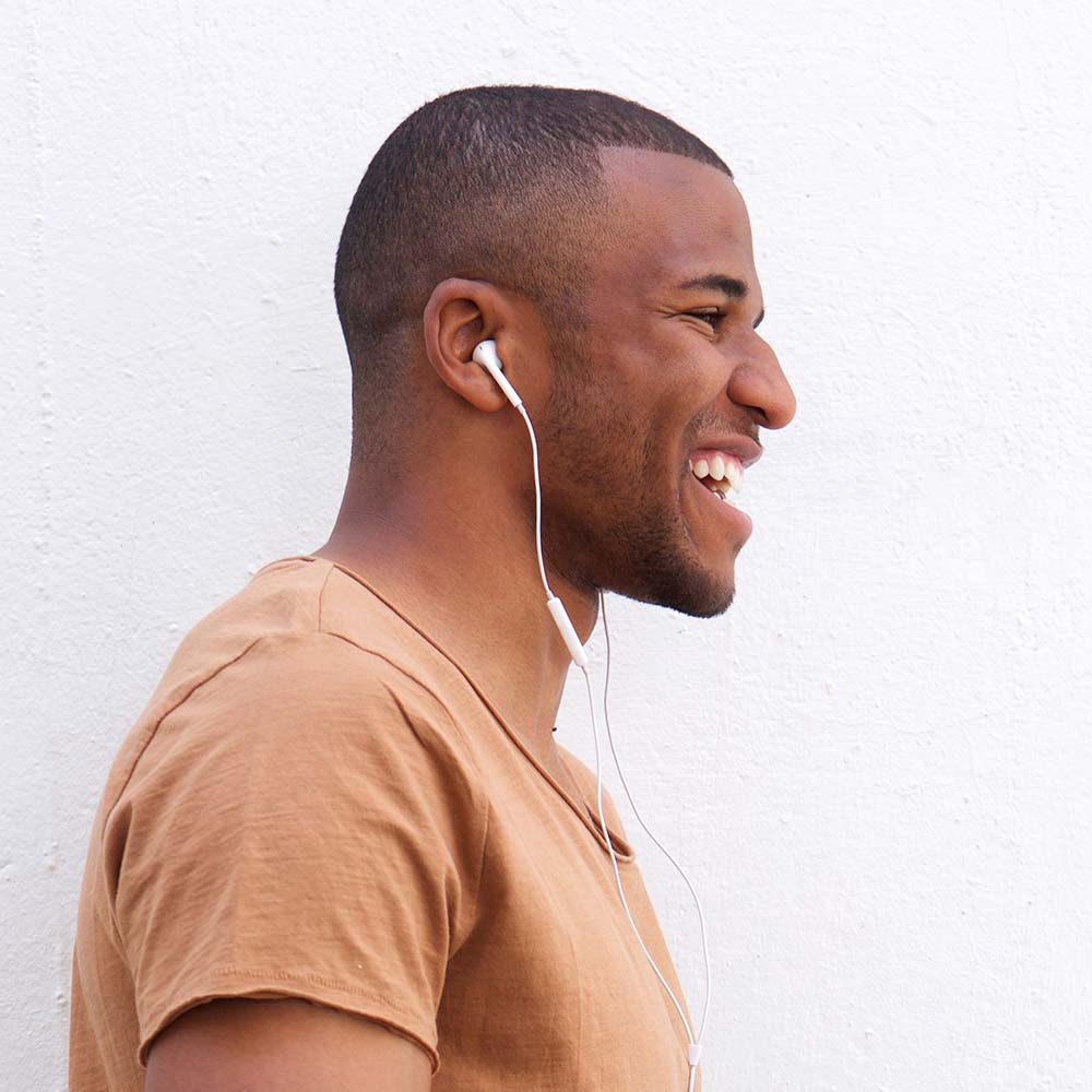 portrait-of-afro-american-man-listening-music-agai-CAJQK28.jpeg